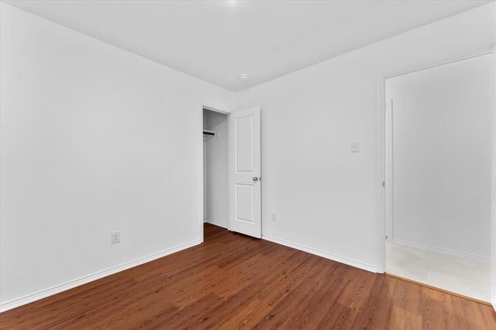 211 Herman Lane Princeton, TX 75407 - Photo 21 of 40 a view of an empty room with wooden floor
