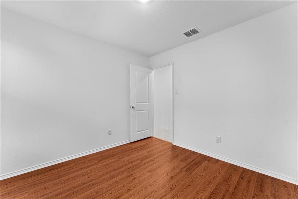 211 Herman Lane Princeton, TX 75407 - Photo 26 of 40 a view of an empty room with wooden floor