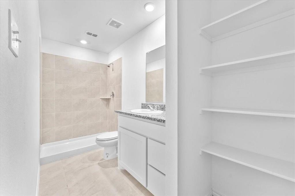 211 Herman Lane Princeton, TX 75407 - Photo 29 of 40 a bathroom with a shower a toilet and a sink