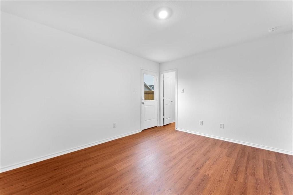 211 Herman Lane Princeton, TX 75407 - Photo 31 of 40 a view of an empty room with wooden floor