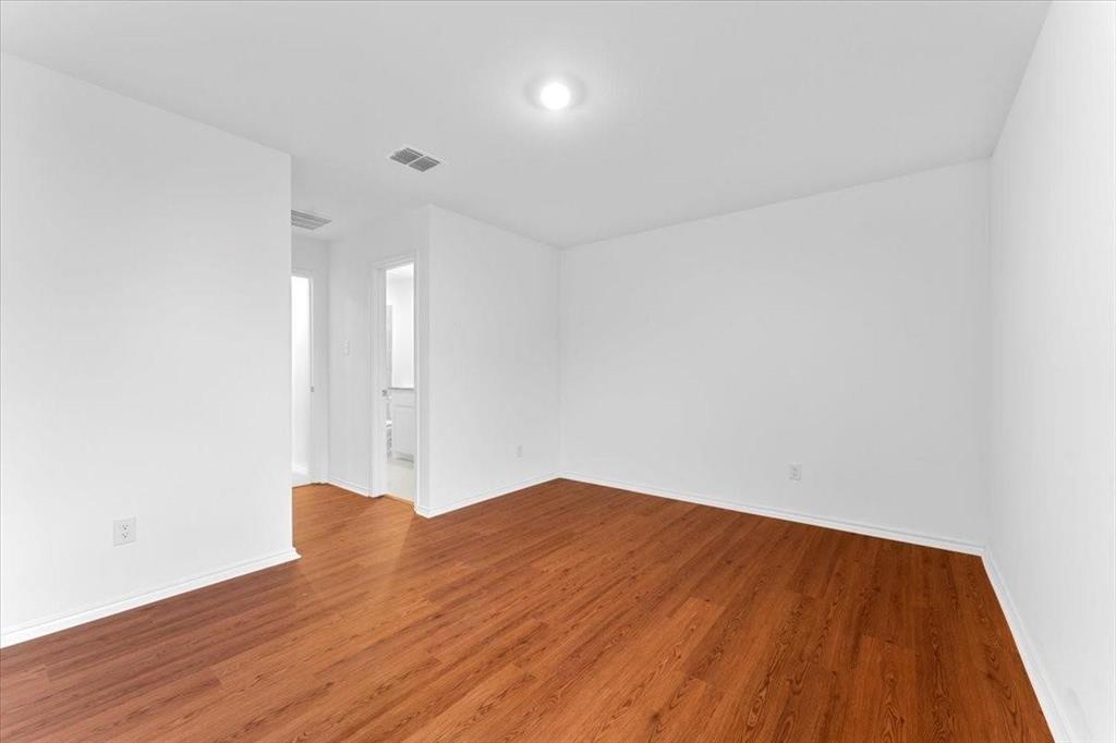 211 Herman Lane Princeton, TX 75407 - Photo 33 of 40 a view of empty room with wooden floor and fan