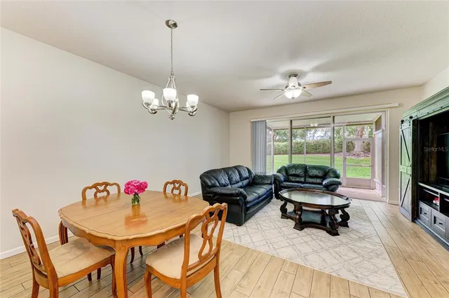 a view of a dining room with furniture and chandelier