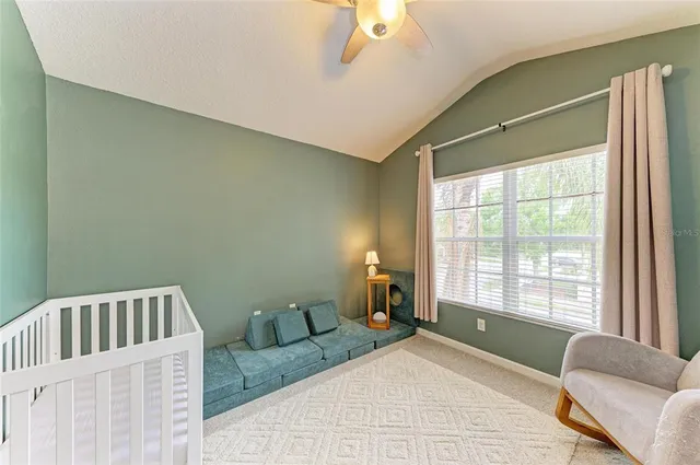 a bedroom with furniture and a book shelf