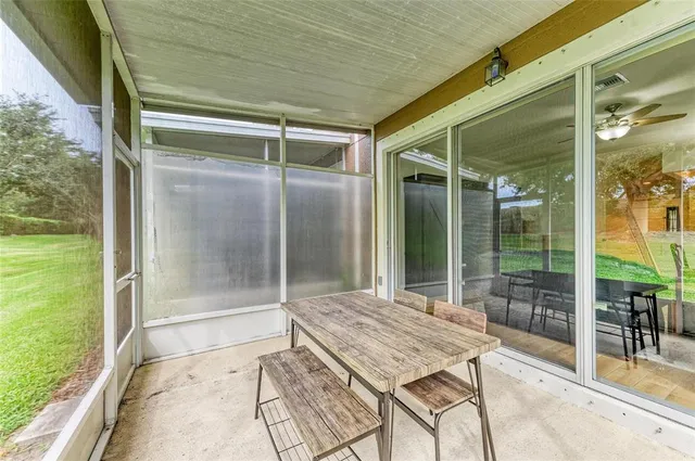 an aerial view of a house with a yard and large trees