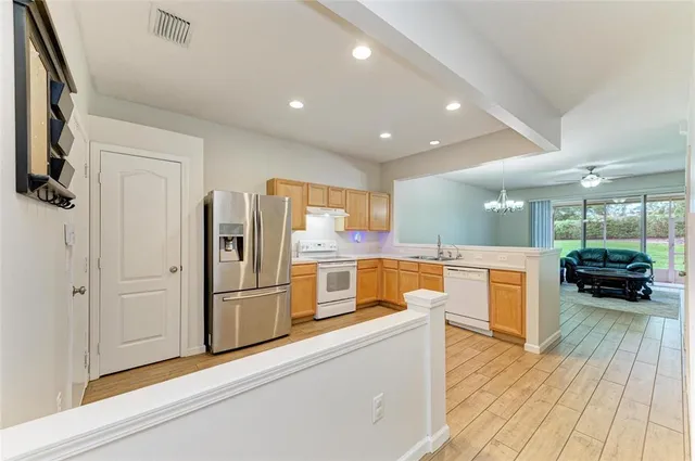 a kitchen with granite countertop a refrigerator and a sink