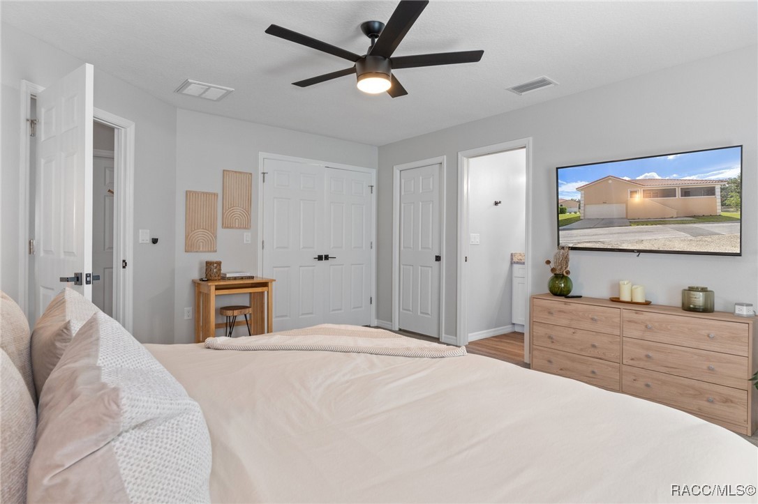 4865 South Tromp Loop Homosassa, FL 34448 - Photo 12 of 30 a bedroom with a bed and a flat screen tv