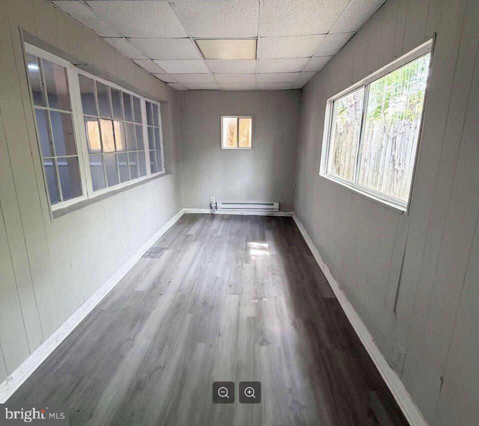 2609 Kane Street Chester, PA 19013 - Photo 2 of 7 an empty room with wooden floor and windows