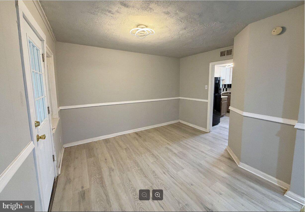 2609 Kane Street Chester, PA 19013 - Photo 4 of 7 wooden floor in an empty room with a window