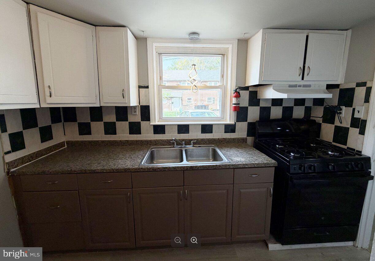 2609 Kane Street Chester, PA 19013 - Photo 5 of 7 a kitchen with a sink stove and cabinets