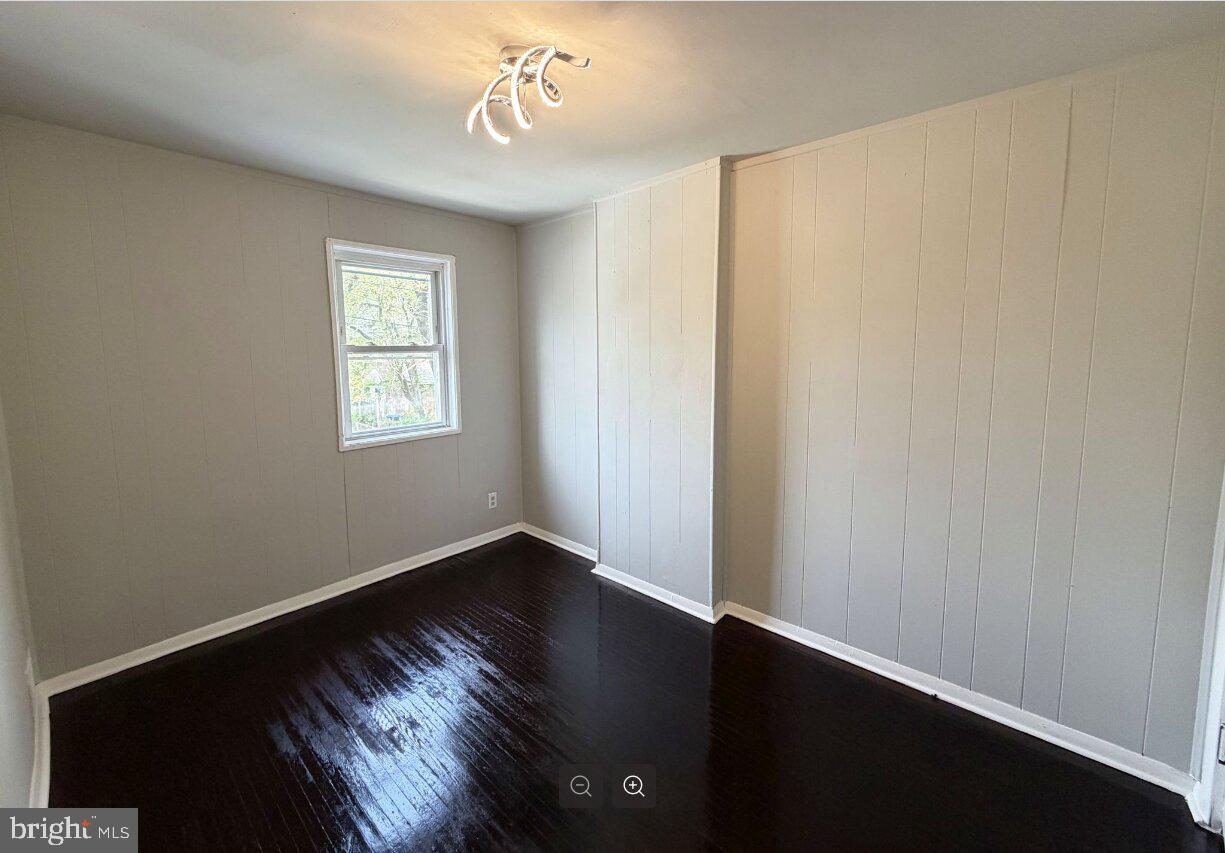 2609 Kane Street Chester, PA 19013 - Photo 7 of 7 a view of an empty room with wooden floor and a window