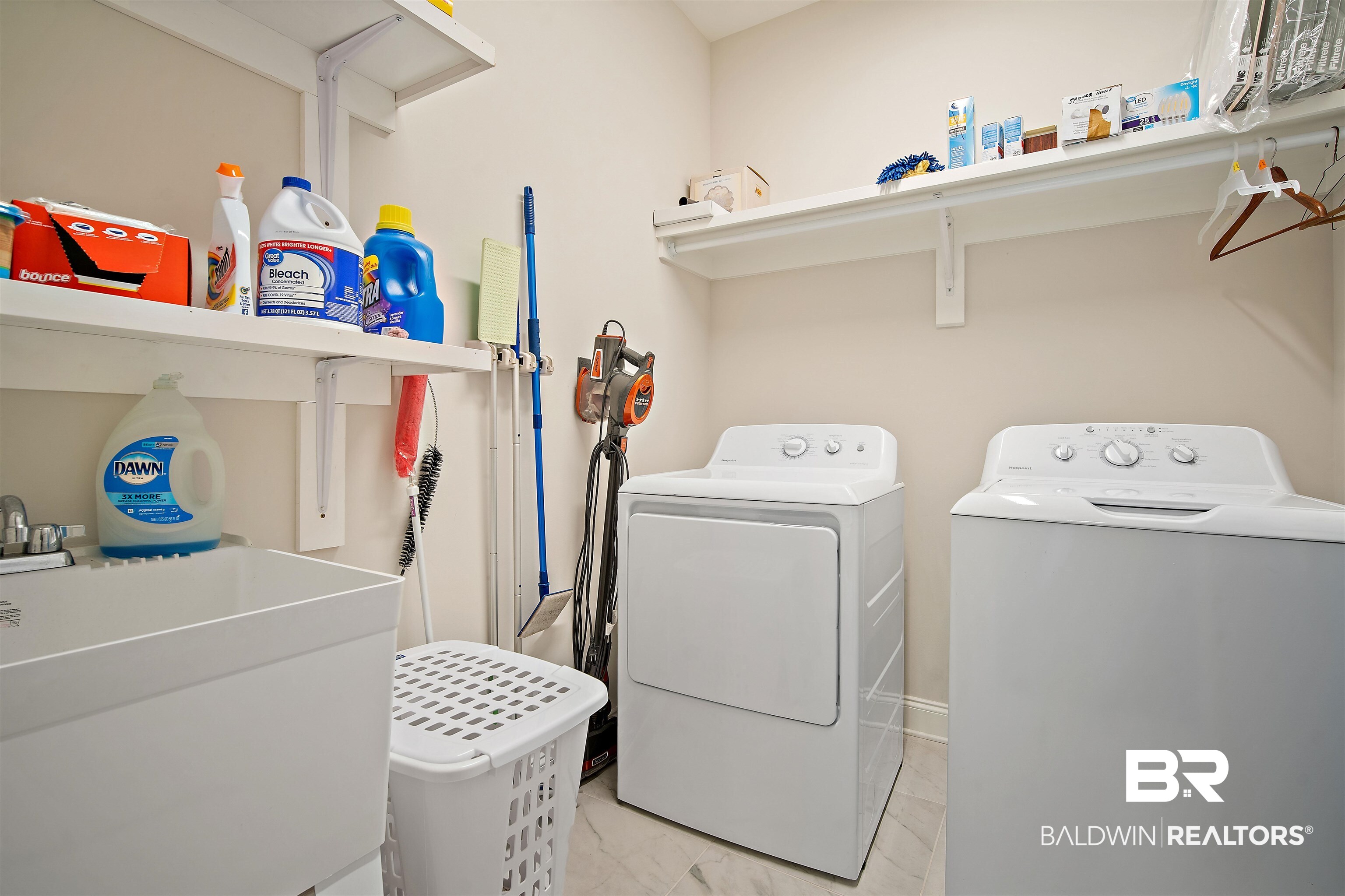 969 Charleston Loop Fairhope, AL 36532 - Photo 26 of 30 Laundry room featuring sink, washing machine and clothes dryer, and light tile patterned flooring