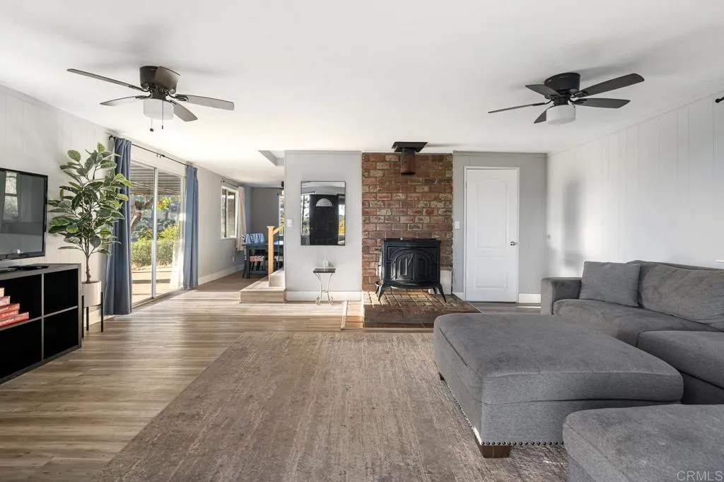 26086 Bear Valley Heights Road Valley Center, CA 92082 - Photo 55 of 65 a living room with furniture and a fireplace