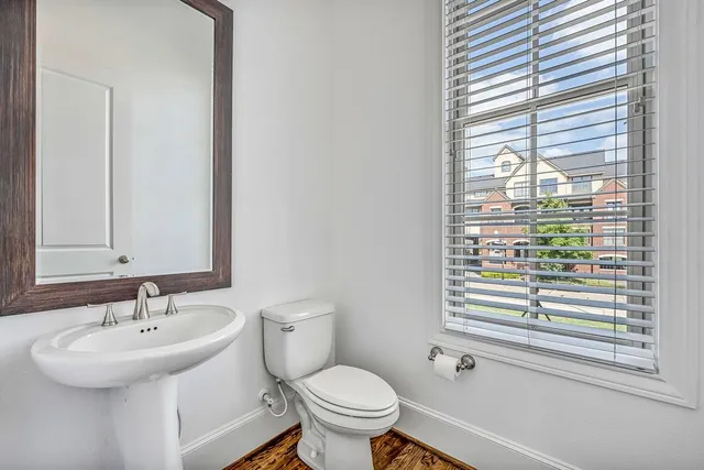 a bathroom with a sink a toilet and a mirror