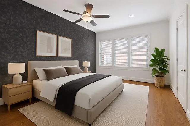 a spacious bedroom with a bed and a potted plant