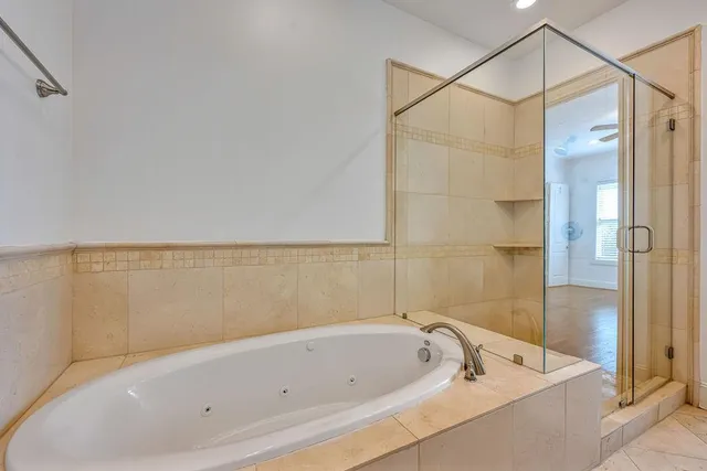 a bathroom with a bathtub and shower
