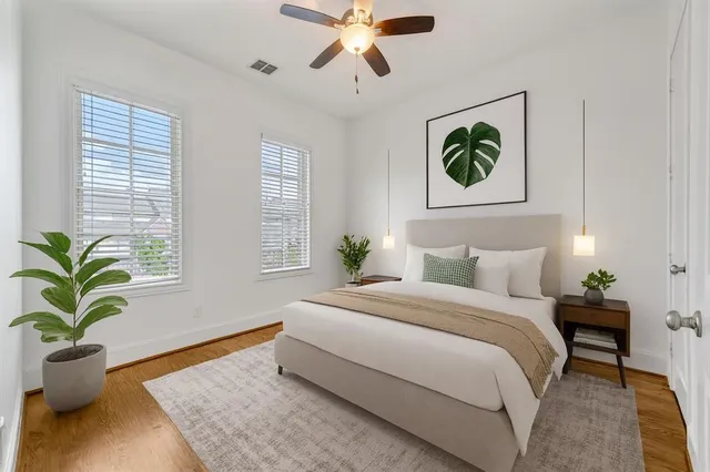 a bedroom with a bed potted plant and a window