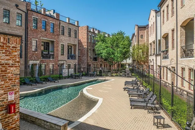a view of a brick building next to a yard