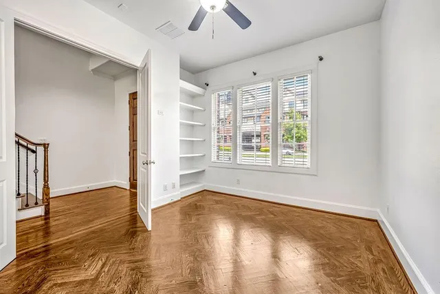 wooden floor in an empty room with a window