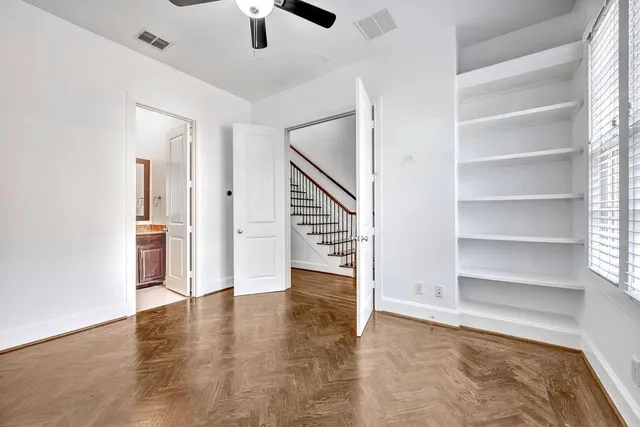a view of an empty room with a kitchen and a window