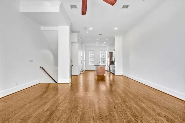 a view of empty room with wooden floor