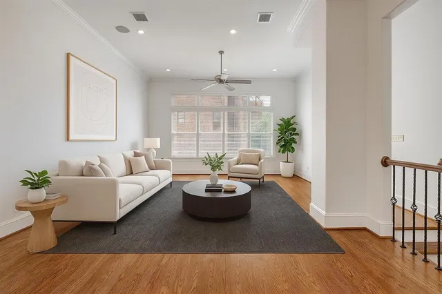 a living room with furniture and a wooden floor