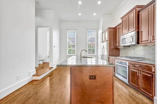 a kitchen with stainless steel appliances granite countertop a sink and cabinets
