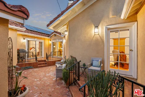 a view of a porch with chairs and backyard