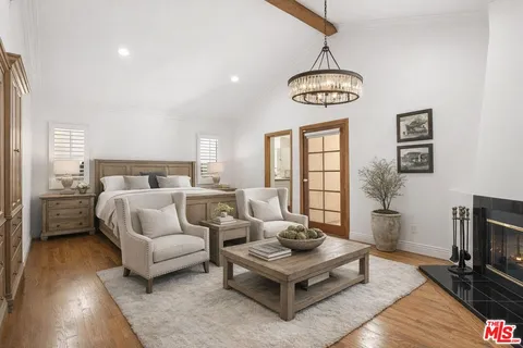a bedroom with furniture and a window