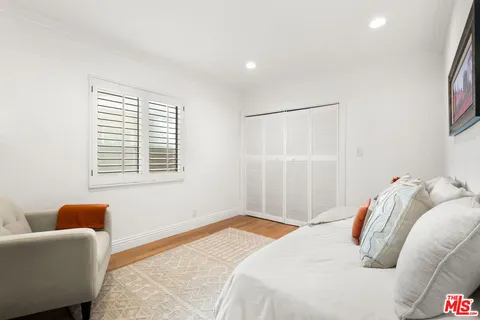 a bedroom with a bed and a couch