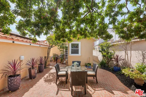 a view of backyard with outdoor seating and plants