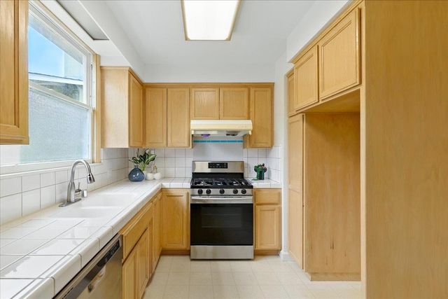 a view of a kitchen with a sink cabinets and a window