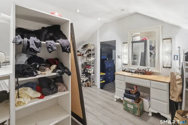a view of a hallway and a livingroom with wooden floor