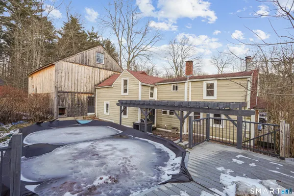 a view of a house with backyard and sitting area