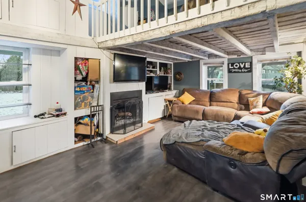 a living room with furniture and a fireplace
