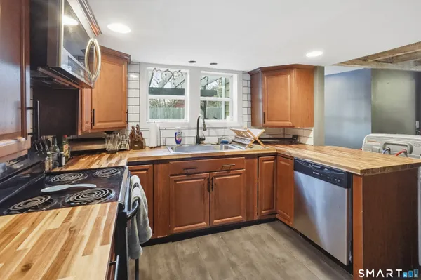 a kitchen with a sink stove and cabinets