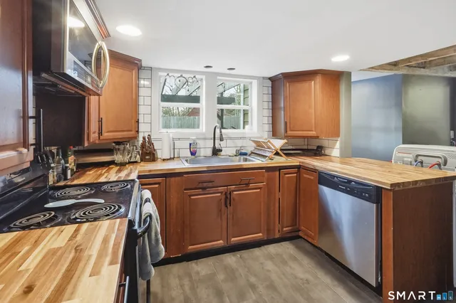 a kitchen with a sink stove and cabinets