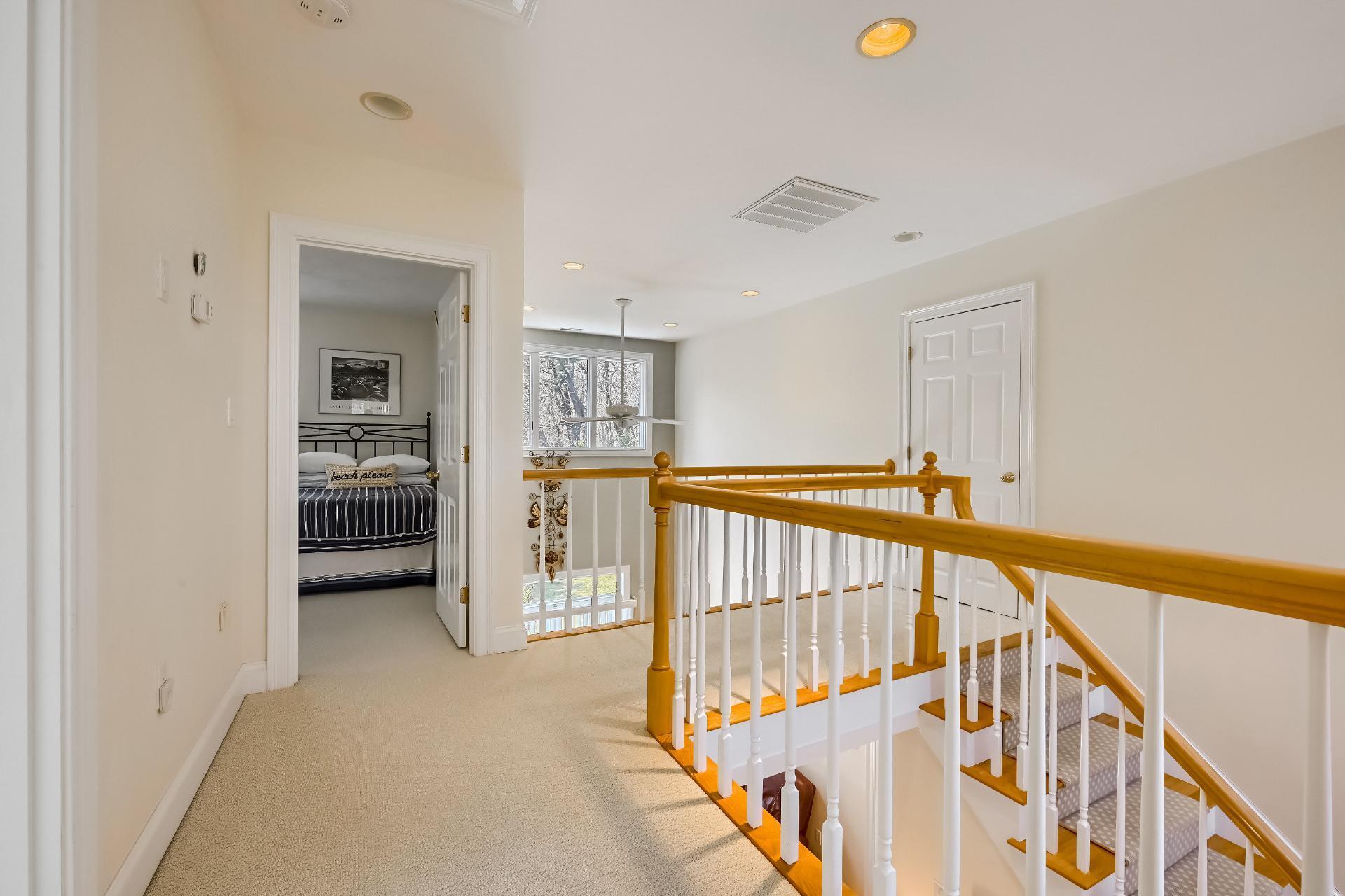 4 Tide Run Mashpee, MA 02649 - Photo 20 of 46 a view of a hallway with wooden floor and stairs