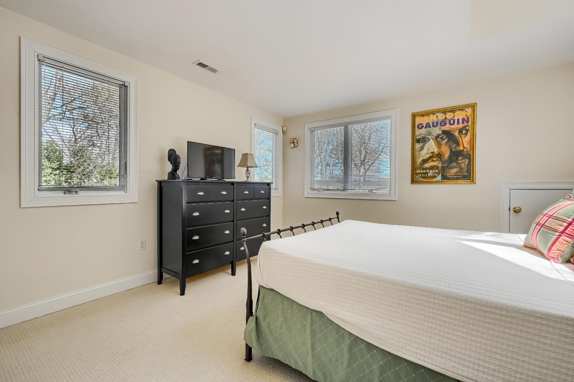 4 Tide Run Mashpee, MA 02649 - Photo 23 of 46 a bedroom with a bed and a tv on dresser