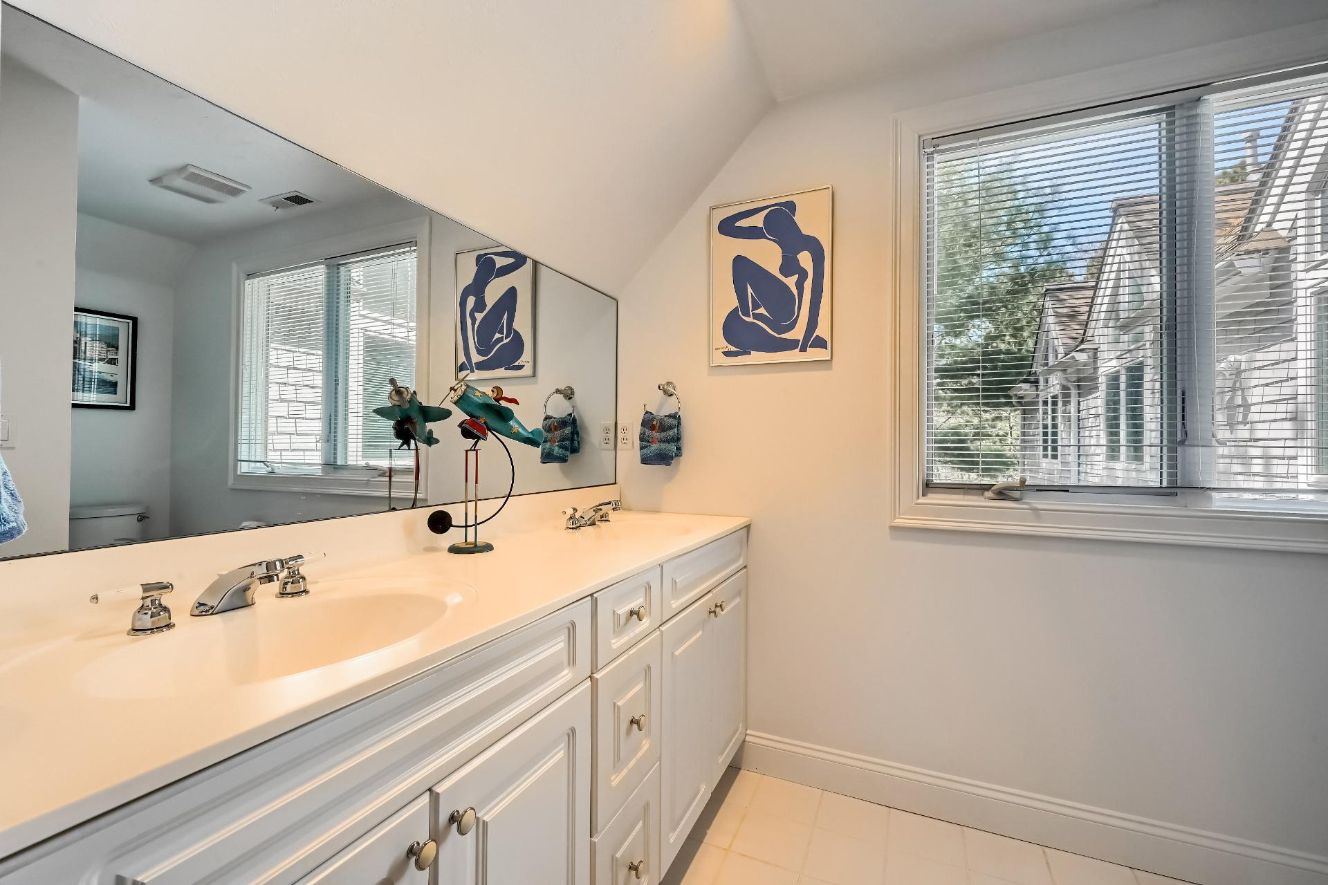 4 Tide Run Mashpee, MA 02649 - Photo 27 of 46 a bathroom with a sink and a large mirror next to a window