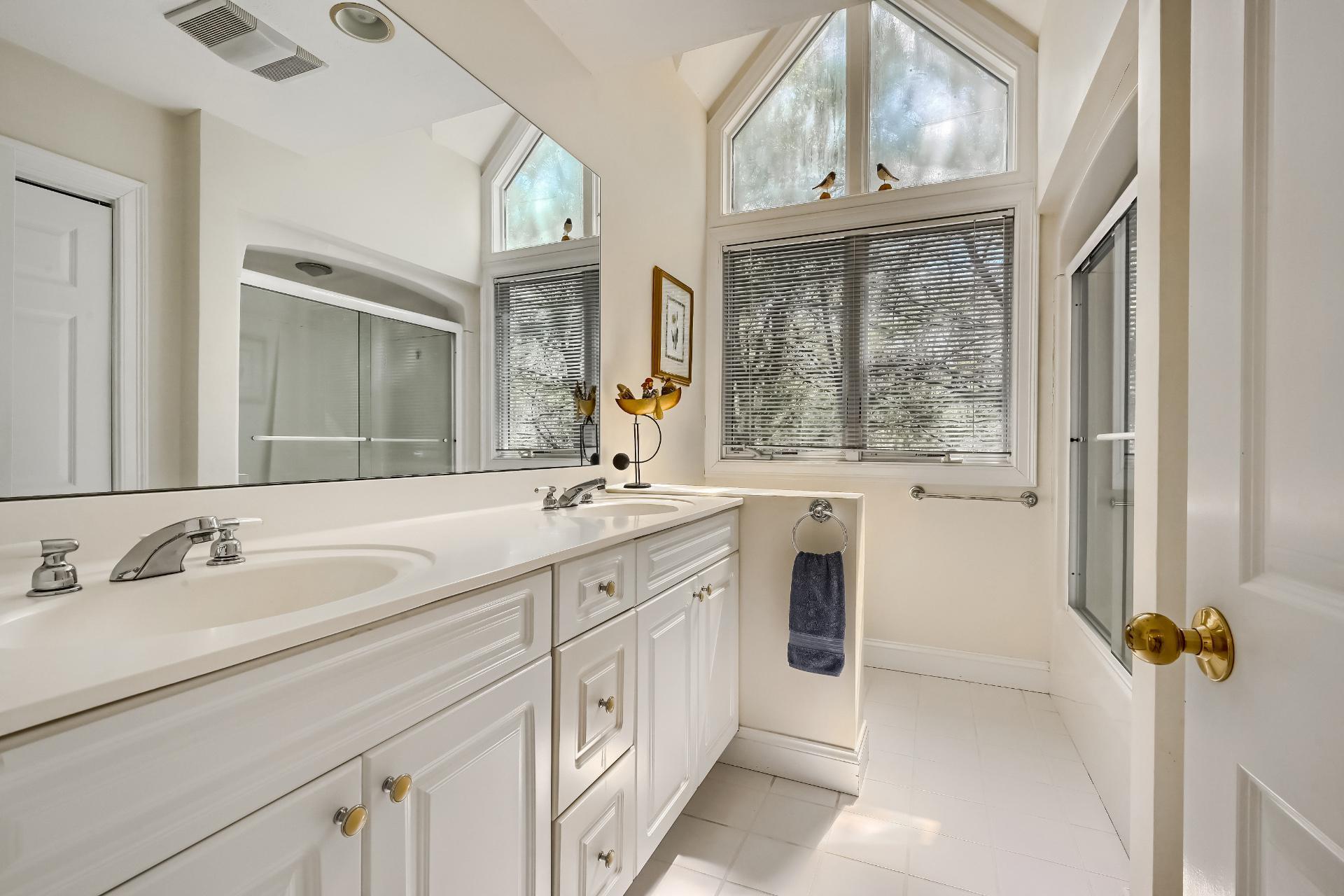 4 Tide Run Mashpee, MA 02649 - Photo 29 of 46 a spacious bathroom with a double vanity sink a mirror a window and a bathtub