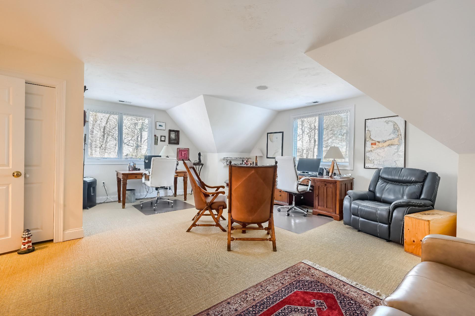 4 Tide Run Mashpee, MA 02649 - Photo 31 of 46 a living room with furniture and a lamp