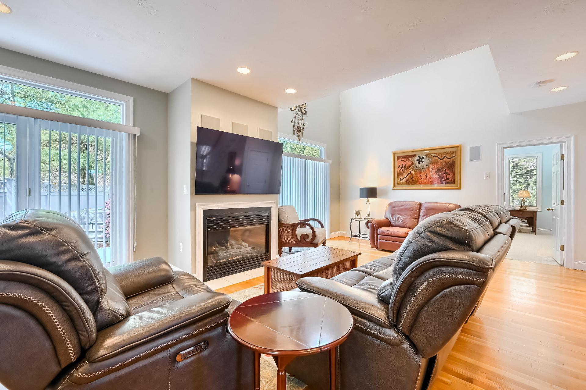 4 Tide Run Mashpee, MA 02649 - Photo 6 of 46 a living room with fireplace furniture and a flat screen tv