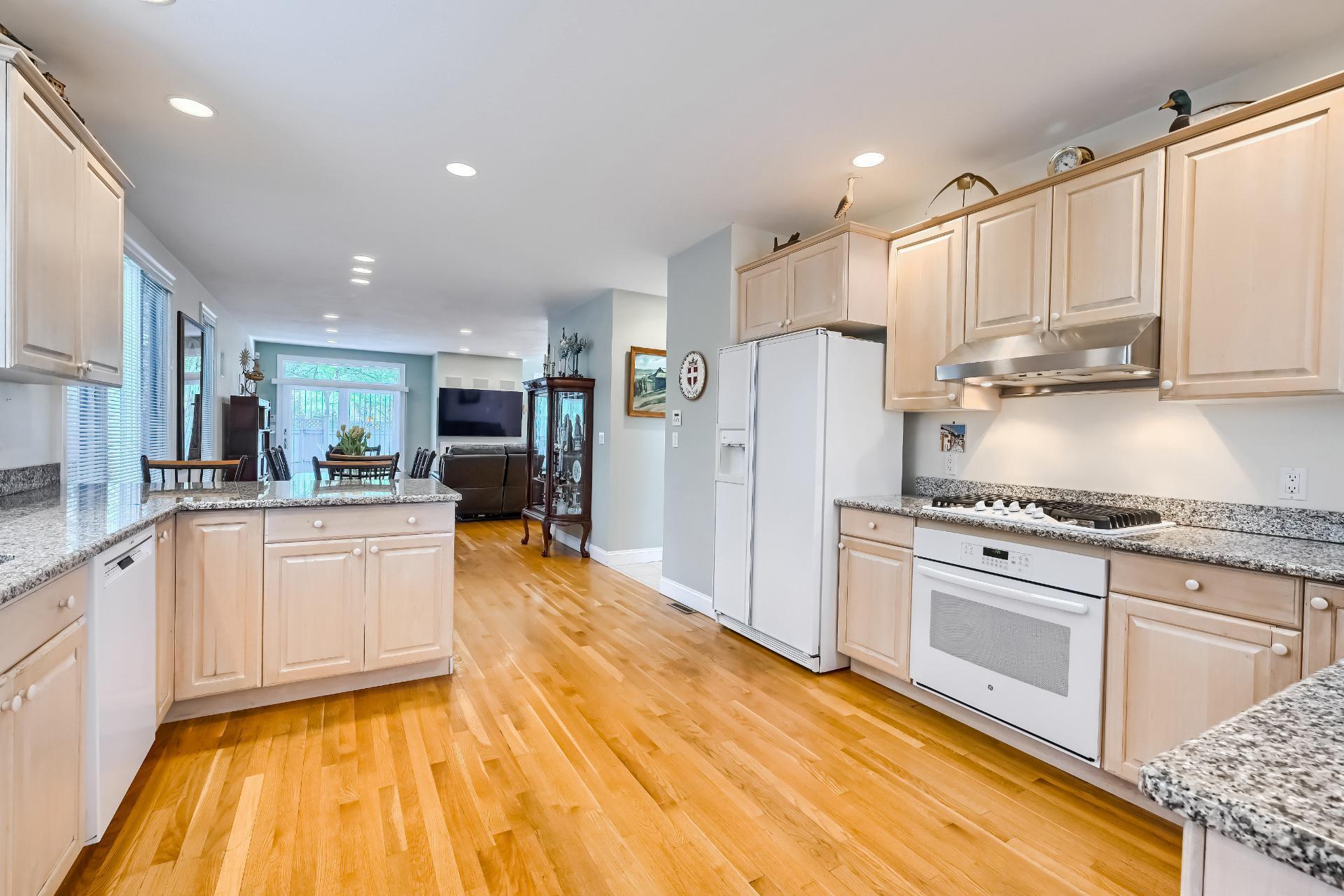 4 Tide Run Mashpee, MA 02649 - Photo 8 of 46 a kitchen with stainless steel appliances granite countertop a refrigerator sink and white cabinets