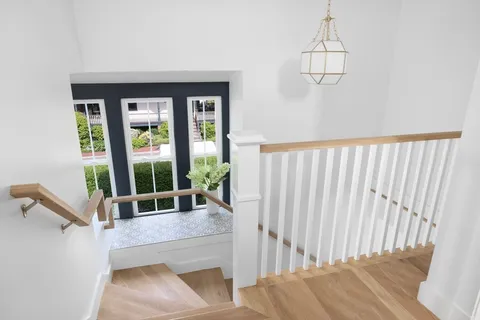 a living room with furniture and a floor to ceiling window
