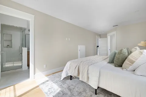 a bedroom with a bed and a large mirror