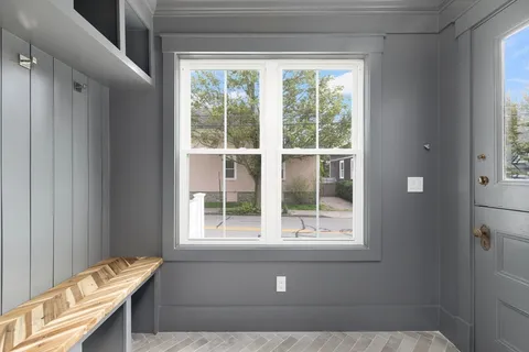 a living room with a bed and a window