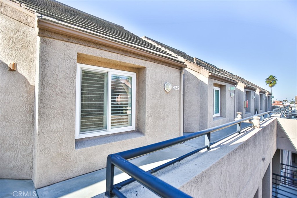 1200 Pacific Coast Highway, Unit 423 Huntington Beach, CA 92648 - Photo 16 of 40 a balcony with chairs and wooden floor