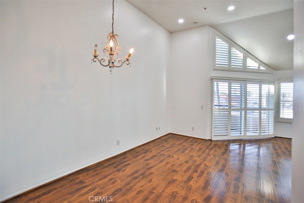 1200 Pacific Coast Highway, Unit 423 Huntington Beach, CA 92648 - Photo 25 of 40 a view of an empty room with wooden floor and a window