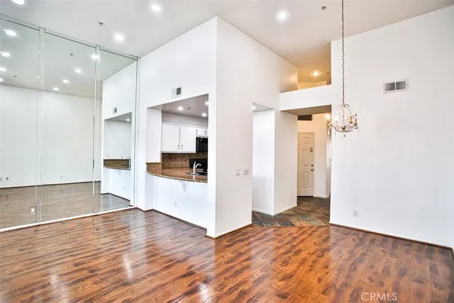 a view of a kitchen cabinets and a room wooden floor