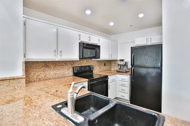 a kitchen with a refrigerator sink and microwave